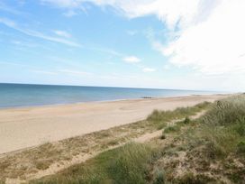 A beach with sand and water at Boa Vista in Bacton