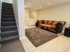 A living room with a sofa and rug at Cartref Pen Y Ball near Holywell