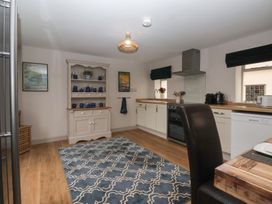 A kitchen featuring appliances and a dining table at The Old Vicarage Annex Hornsea