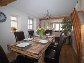 A dining room with a wooden table and chairs at The Old Vicarage Annex in Hornsea