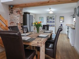 A dining room with a table set and flowers at The Old Vicarage Annex in Hornsea