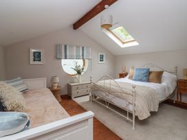 A bedroom with a bed and a window at The Old Vicarage Annex Hornsea