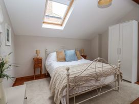 A bedroom with a bed and wardrobe at The Old Vicarage Annex Hornsea
