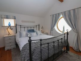 A bedroom with a bed and nightstand at The Old Vicarage Annex in Hornsea