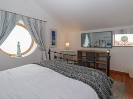 A bedroom with a bed and a lighthouse decoration at The Old Vicarage Annex in Hornsea