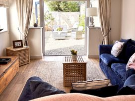 A living room with a view of the garden at The Old Coach House at The Vicarage Mappleton near Hornsea