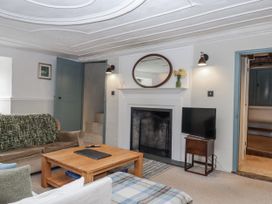 A living room with a coffee table and TV at Westacombe Farm in Dunsford