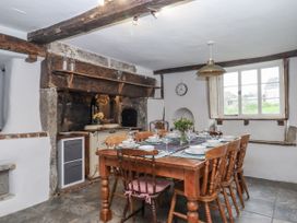 A dining room with a wooden table and chairs at Westacombe Farm Dunsford