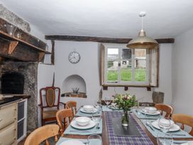 A dining room with a table set for a meal at Westacombe Farm in Dunsford