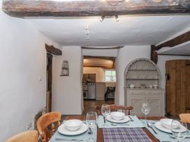 A dining room with a table set for dinner at Westacombe Farm in Dunsford