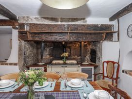 A kitchen with a dining table and a range cooker at Westacombe Farm in Dunsford