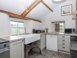 A kitchen with a sink and appliances at Westacombe Farm in Dunsford