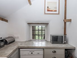 A kitchen with a window and appliances at Westacombe Farm in Dunsford