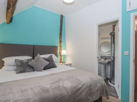 A bedroom with a bed and en-suite bathroom at Westacombe Farm in Dunsford