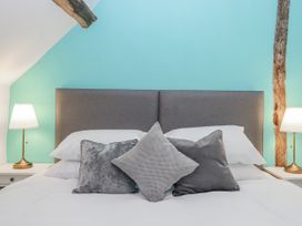 A bedroom with a bed and lamps at Westacombe Farm in Dunsford