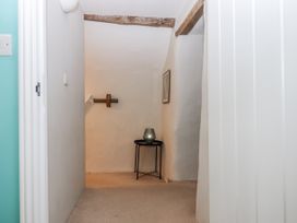 A hallway with a table and vase at Westacombe Farm in Dunsford