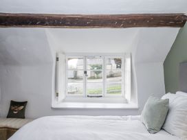 A bedroom with a bed and window at Westacombe Farm in Dunsford