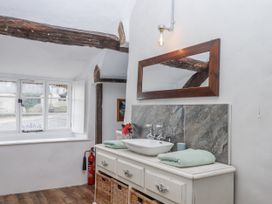 A bathroom with a sink and mirror at Westacombe Farm in Dunsford