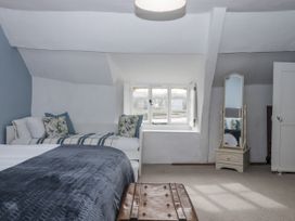 A bedroom with a bed, mirror and window at Westacombe Farm in Dunsford