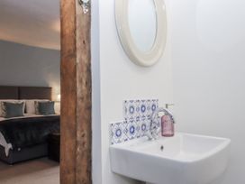 A bathroom with wash basin and mirror visible at Westacombe Farm Dunsford