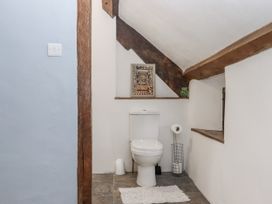 A bathroom with a toilet and shelf at Westacombe Farm in Dunsford