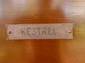 A metal nameplate with the word KESTREL mounted on a wooden surface at Kestrel in Withern near Alford