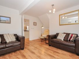 A living room with sofas and an armchair at Kernyk Camelford