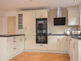A kitchen with cabinets and appliances at Kernyk in Camelford