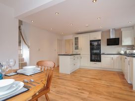 A kitchen with a dining table and chairs at Kernyk in Camelford