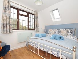 A bedroom with a bed and window at Kernyk in Camelford