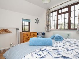 A bedroom with a bed and towels arranged on top at Kernyk in Camelford
