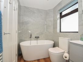 A bathroom with a bathtub and toilet at Kernyk in Camelford