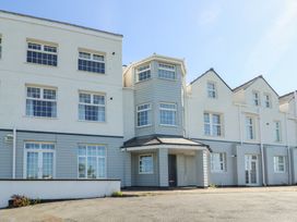 The exterior of a multi-story building with multiple windows and doors