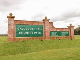 A brick entrance sign for Caldecott Hall Country Park on a grass lawn