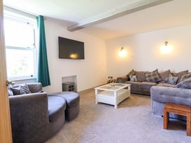 A living room with seating and a television at The Farmhouse in Oswestry