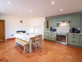 A kitchen with a table and chairs at The Farmhouse in Oswestry