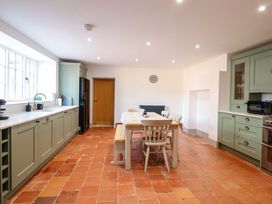 A kitchen with a table and chairs at The Farmhouse in Oswestry