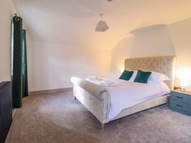 A bedroom with a bed and nightstand at The Farmhouse in Oswestry