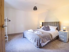 A bedroom with a bed and bedside tables at The Farmhouse in Oswestry