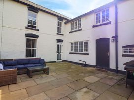 An outdoor area featuring a couch and coffee table at The Farmhouse in Oswestry