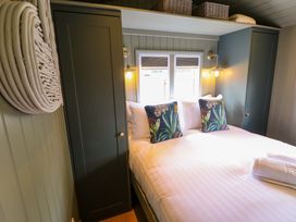 A bedroom with a bed and storage cabinets at Bluebell in Grimsby