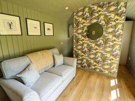 A snug with a sofa and decorative wall at Primrose in Grimsby