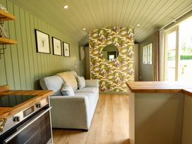 A living room with a sofa and kitchen countertop at Primrose in Grimsby