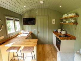A kitchen with a bar counter and stools at Primrose in Grimsby