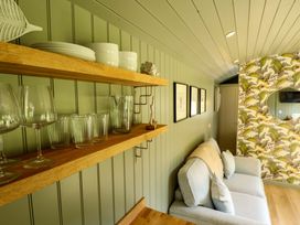 A living room with shelves containing glasses and plates at Primrose in Grimsby