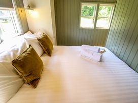 A bedroom with a bed, pillows, and towels at Primrose in Grimsby