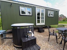 An outdoor area with a hot tub, table, and chairs at Primrose, Grimsby