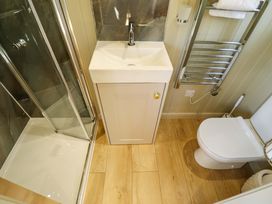 A bathroom with a sink, shower, and toilet at Magnolia in Grimsby