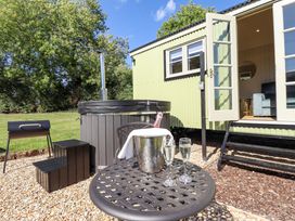 An outdoor area with a hot tub, table and chairs at Magnolia in Grimsby