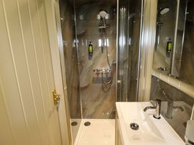 A bathroom with a shower and sink at Snowdrop in Grimsby
